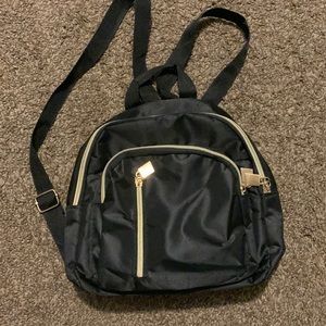 mini black backpack, 3 compartments, gold zippers, holds quite a lot